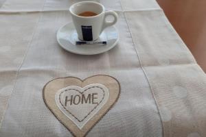 a heart on a table with a cup of coffee at Сладко студио в Пирин с голф и СПА комплекс in Razlog
