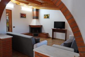 a living room with a couch and a fireplace at Attico La Terrazza in Viagrande