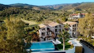 an aerial view of a resort with mountains in the background at Perikleshills in Thermisia