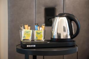 a tea kettle and two glasses on a table at The Gold Bank in Prague