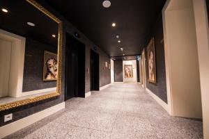 a hallway with paintings on the walls at The Gold Bank in Prague