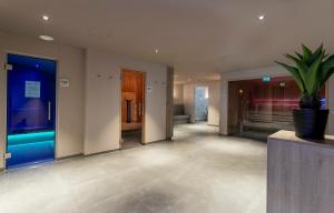 a hallway with a potted plant in a building at Country Hotel Timmendorfer Strand in Timmendorfer Strand