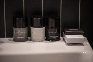 a group of four bottles ofmetics sitting on a shelf at The Gold Bank in Prague