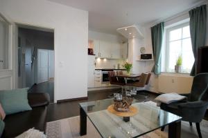 a living room with a couch and a table at Villa Seydlitz - by Rujana in Binz