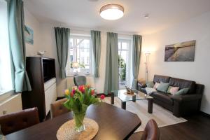 a living room with a vase of flowers on a table at Villa Seydlitz - by Rujana in Binz