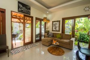 a living room with a couch and a table at Anindya Homestay in Sanur
