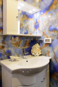 a bathroom with a sink and a mirror at Luxury Lake View in Agios Nikolaos +18 photos