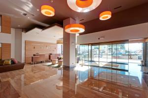 a lobby of a building with orange lights at Hotel Vigo Los Galeones Affiliated by Meliá in Vigo