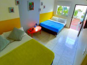 a small room with two beds and a table at Casa Azul Boutique Hostel in Pereira