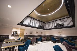 a restaurant with wooden tables and blue chairs at The Gold Bank in Prague