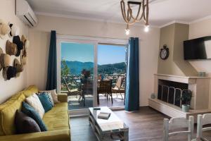 a living room with a couch and a table with a view at Casa De Blue in Kariá