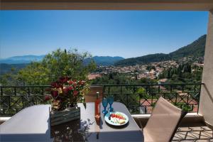 a table with a plate of food on a balcony at Casa De Blue in Kariá
