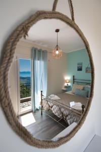 a bedroom with a bed and a view of a balcony at Casa De Blue in Kariá