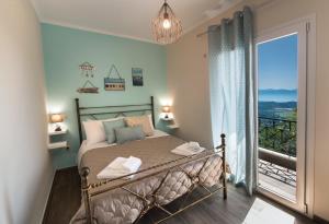 a bedroom with a bed and a large window at Casa De Blue in Kariá