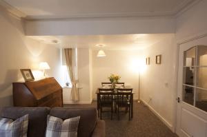 a living room with a couch and a table at Allan Stream Apartment in Bridge of Allan