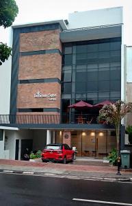 a red car parked in front of a building at LeGreen Suite Sudirman in Jakarta