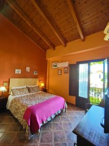 a bedroom with a large bed and a large window at Hotel Doñana Blues in Matalascañas