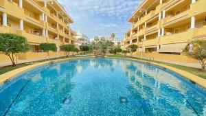 a large swimming pool in the middle of a building at Cascada de las Marinas in Denia