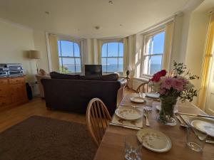 a living room with a table and a couch at Sea View in Shanklin