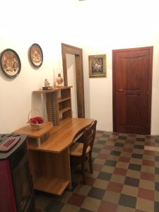 a dining room with a wooden table and a door at Bed and Breakfast Family Palazzo Stillitano Stilo in Stilo +22 photos