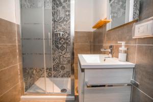 a bathroom with a sink and a shower at La Finestra Sul Castello - Modica Panoramic Flats in Modica