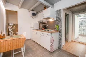 a kitchen with white cabinets and a counter top at La Finestra Sul Castello - Modica Panoramic Flats in Modica +25 photos