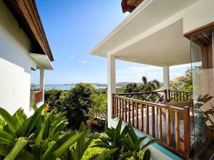 a balcony of a house with a view of the ocean at The Endless Summer Resort in Bumbang
