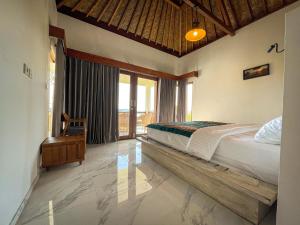 a bedroom with a bed and a large window at The Endless Summer Resort in Bumbang