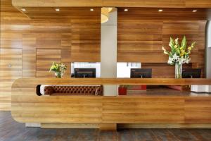 un vestíbulo de oficina con paneles de madera y escritorios en Asia Hotel & Spa Leoben, en Leoben