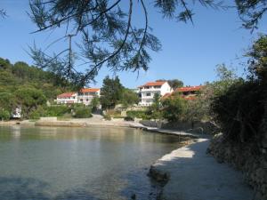 a view of a river with houses in the background at Apartment Riko - accomodation "with" the Adriatic sea in Kampor