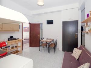 a kitchen and dining room with a table and chairs at fam central apt in Heraklio Town