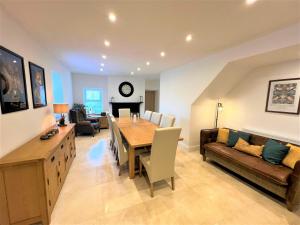 a living room with a dining room table and a couch at Beautiful House Located Near Kielder Reservoir in Kielder