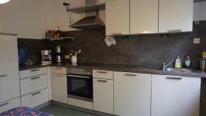 a kitchen with white cabinets and a sink at Ferienwohnung Aloisia in Meersburg