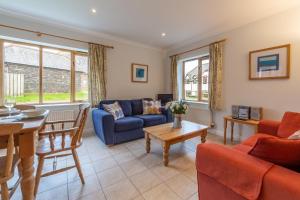 a living room with a couch and a table at September Cottage in Wadebridge