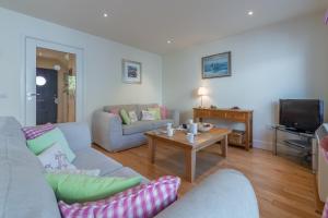 a living room with a couch and a table at 4 Pentire Rocks in Polzeath