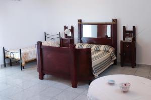 sypialnia z 2 łóżkami, lustrem i stołem w obiekcie B&B LA CASA DEI FIORI w mieście Amorosi +9 zdjęć
