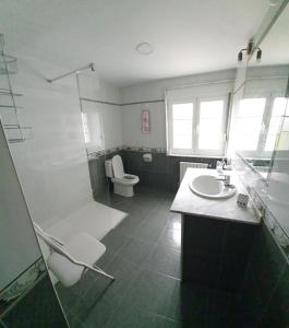 a bathroom with a shower and a toilet and a sink at Casa Arquella in Cartavio