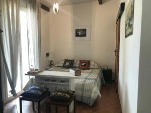 a bedroom with a bed with a desk and two chairs at CARPE DIEM Stagnone in Marsala