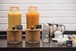 two bottles of orange juice sitting on a counter at The Gold Bank in Prague