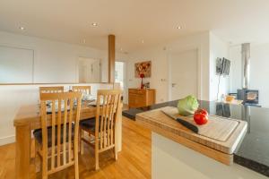 a kitchen and dining room with a table and chairs at Sea Gem in St. Agnes 