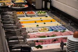 a buffet line with different types of meats and vegetables at The Gold Bank in Prague