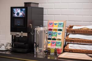 a coffee machine on a counter next to baskets of bread at The Gold Bank in Prague