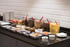 a buffet of food on a counter with bowls of food at The Gold Bank in Prague