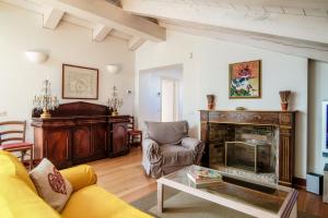 a living room with a couch and a fireplace at Castello di Brusata by Quokka 360 - romantic flat with pool in Mendrisio