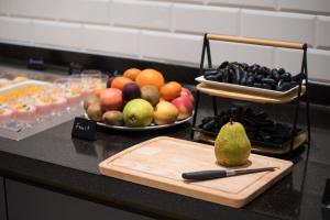 a counter with a cutting board and a plate of fruit at The Gold Bank in Prague