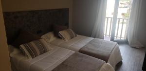 Postel nebo postele na pokoji v ubytování Hotel Balfagón