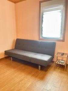 a blue couch in a room with a window at Apartment Lecer 4 in Porta
