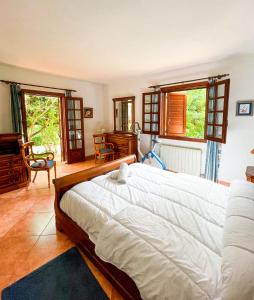 a bedroom with a large white bed and windows at Villa La Torreta REF 056 in Castellón de la Plana +64 photos