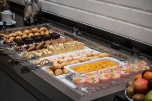 a buffet with many different types of pastries and fruit at The Gold Bank in Prague