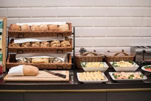 a buffet with bread and other food on a counter at The Gold Bank in Prague